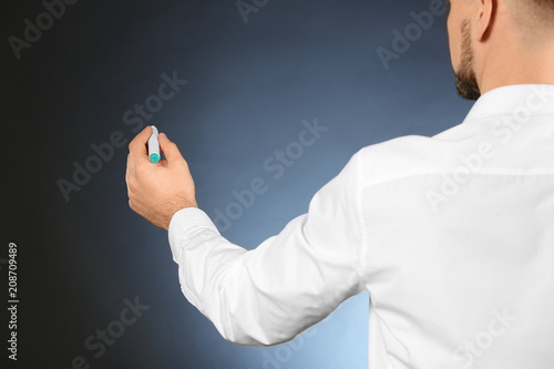 Young businessman writing o...