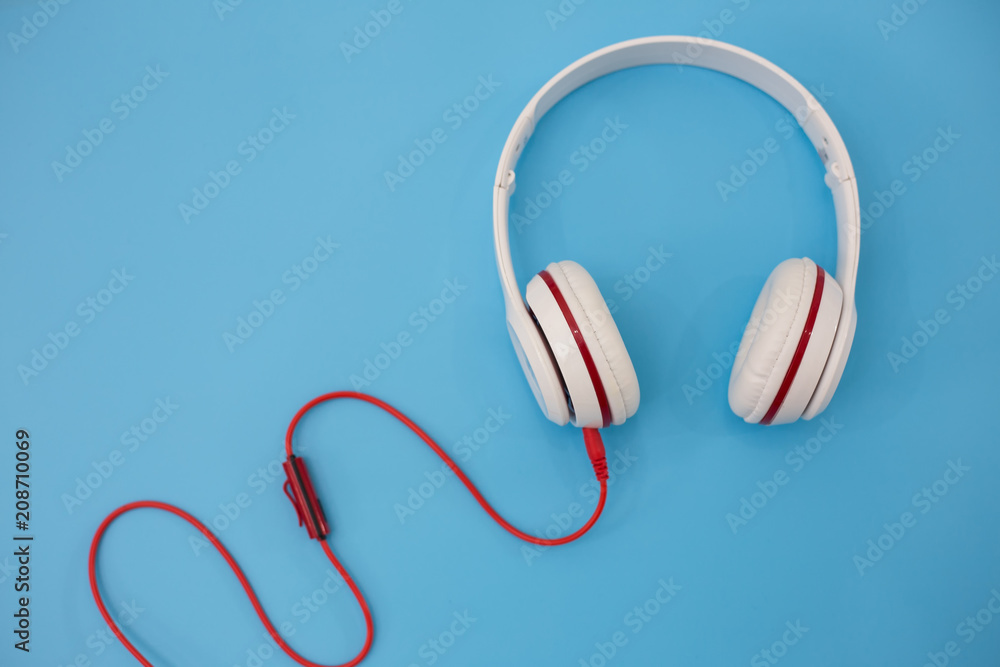 White headphones on blue background. White headphones on blue background.