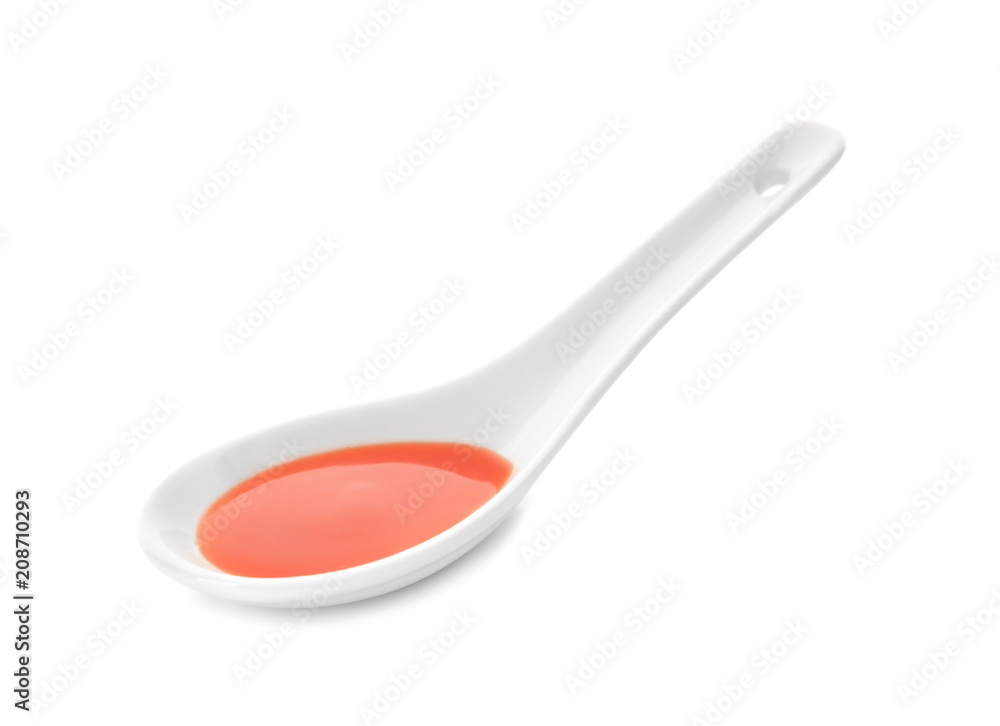 Tomato sauce in spoon on white background Tomato sauce in spoon on white background