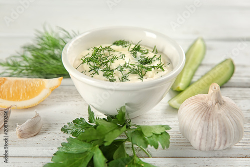 Composition with tartar sauce on white wooden background