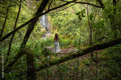 Girl watching the Cascade Blanche waterfall in Salazie, Reunion Island photo