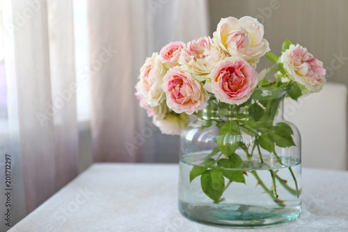 Beautiful bouquet of white and pink roses in the glass. Summer mood