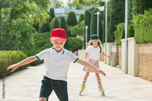 Portrait of a charming teenage couple roller-skating together