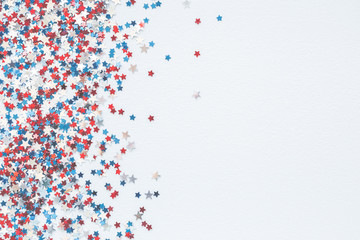 4th of July American Independence Day decorations on pastel blue background. Flat lay, top view, copy space