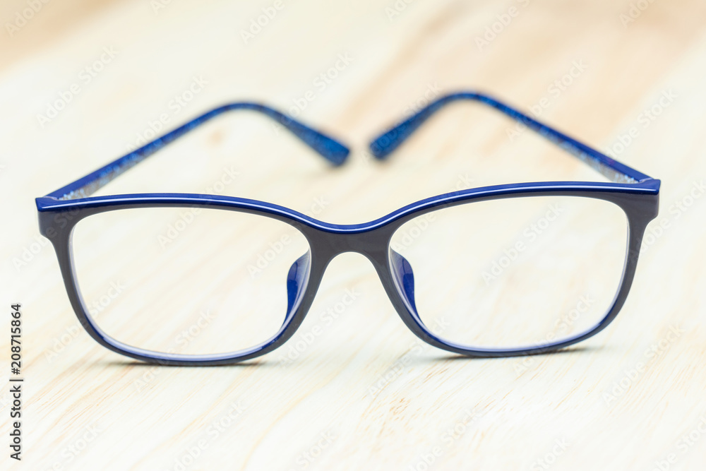 Blue eye glasses on wood table for business, education concept design. Blue eye glasses on wood table for business, education concept design.