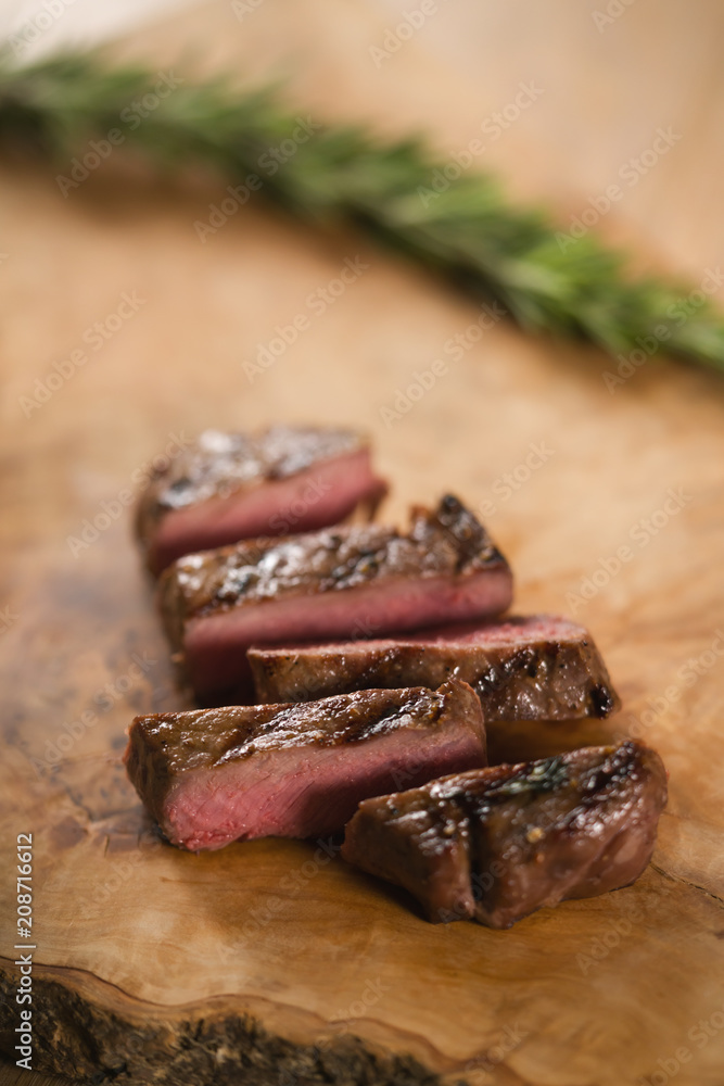 sliced medium filet mignon on wood board sliced medium filet mignon on wood board