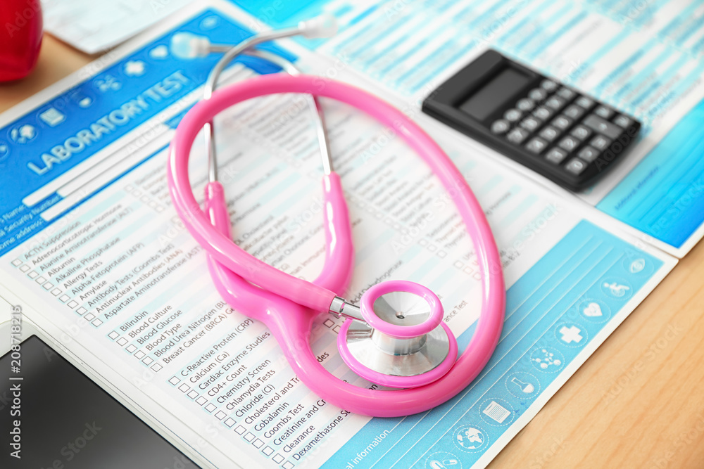 Test results with stethoscope and calculator on table Test results with stethoscope and calculator on table