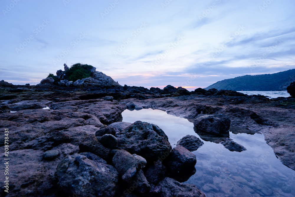 Beautiful landscape with sea, stones and sunset sky.