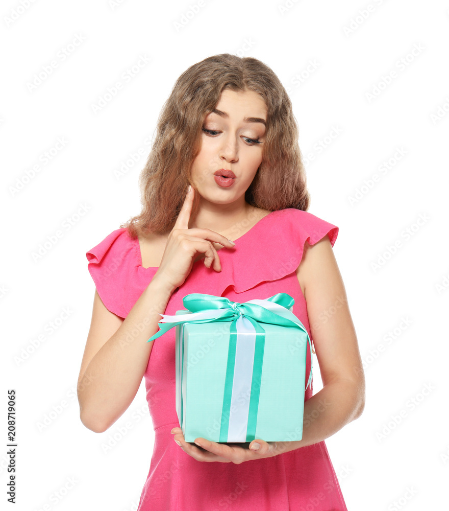 Thoughtful young woman with gift box on white background Thoughtful young woman with gift box on white background