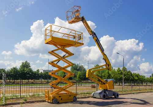 Self propelled wheeled articulated boom lift and scissor lift photo