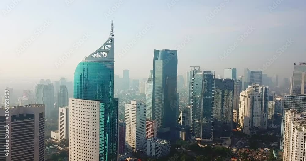 JAKARTA, Indonesia - June 08, 2018: Aerial view of modern office buildings with fog of air pollution in Jakarta city. Shot in 4k resolution JAKARTA, Indonesia - June 08, 2018: Aerial view of modern office buildings with fog of air pollution in Jakarta city. Shot in 4k resolution