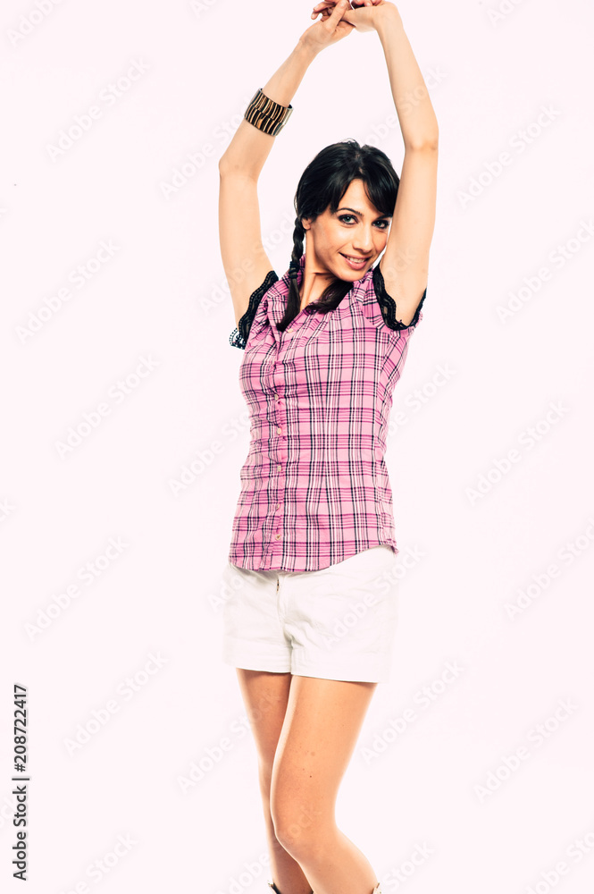 Young caucasian brunette with tail hair having fun in studio. White background, pink shirt dressed. Copy space Young caucasian brunette with tail hair having fun in studio. White background, pink shirt dressed. Copy space
