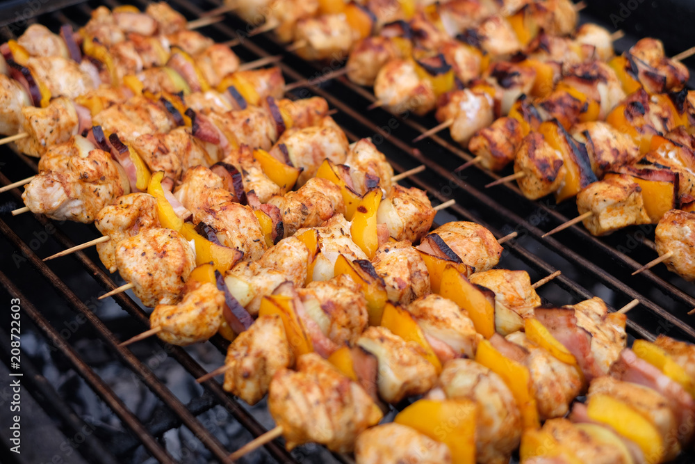Grilled vegetable and meat skewers on a grill pan. Shish kebab from chicken, pepper and bacon