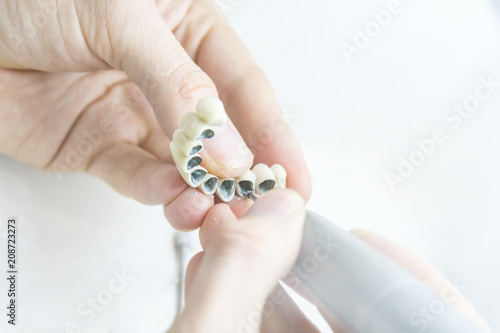 Dental technician tooth prosthetic makeing in laboratory