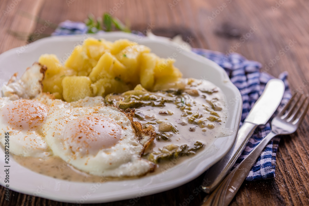 vegetarian meal lettuce sauce with potatoes and fried egg 