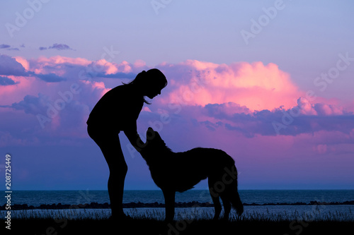 girl and dog on the beach