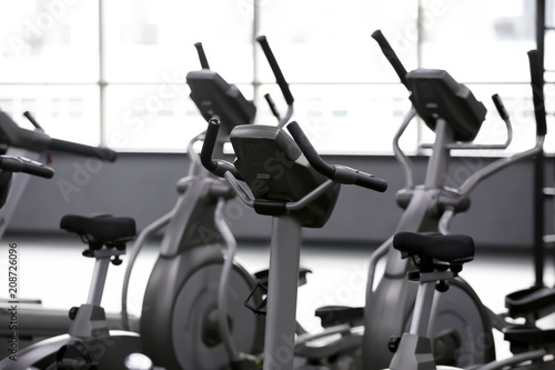 Modern exercise bicycles in gym