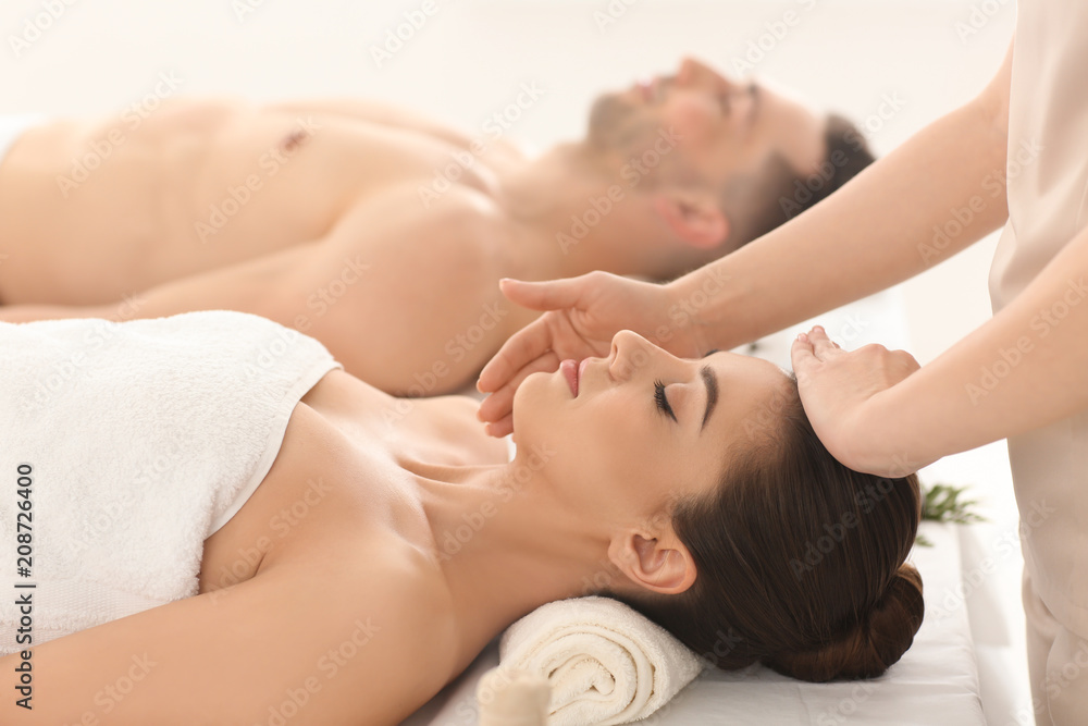 Happy young couple having massage in spa salon Happy young couple having massage in spa salon
