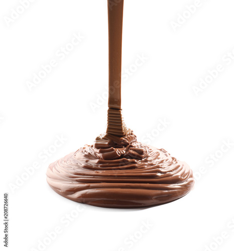 Pouring melted chocolate on white background