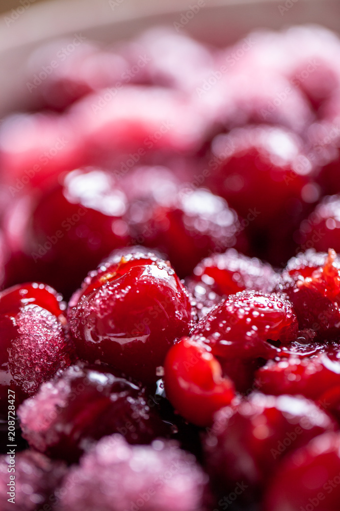Cherry jam. Close up of simmering homemade cherry jam. Cherry and sugar crystal. Stewed cornel (dogwood or cornelian cherry) background or texture. Rfood background. Macro close-up. food photography