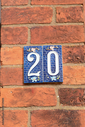 House number 20 sign on ceramic tiles on wall