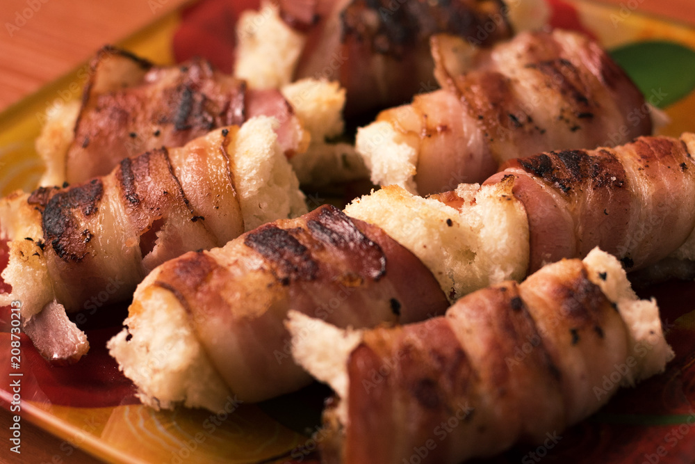 roll with bacon on a plate roll with bacon on a plate