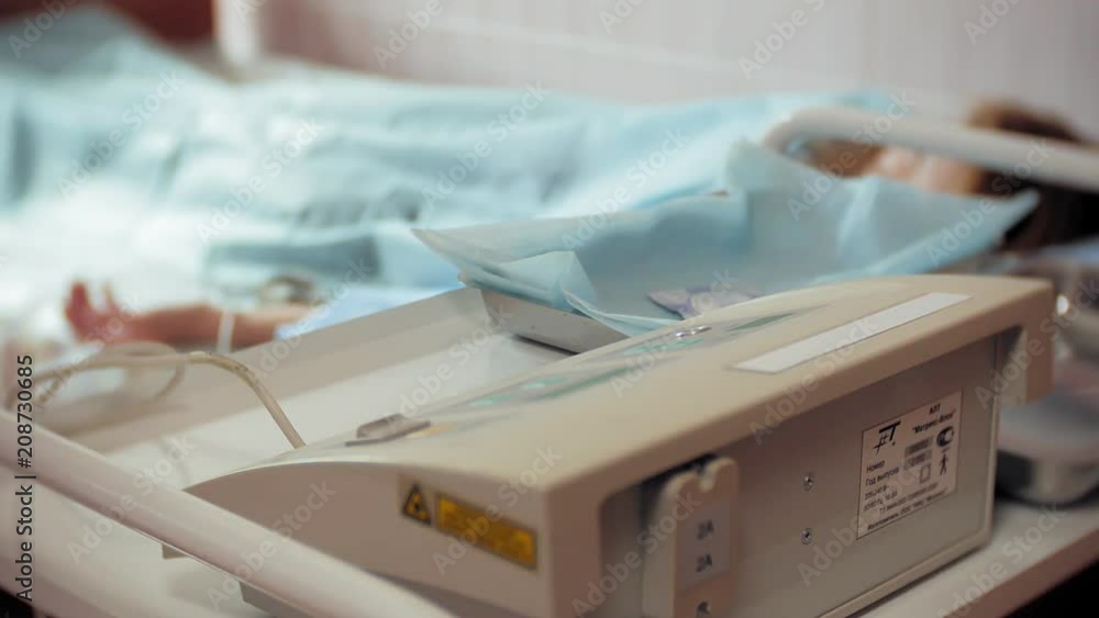A woman in a hospital undergoing UV blood irradiation therapy A woman in a hospital undergoing UV blood irradiation therapy