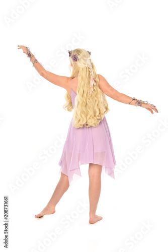 full length portrait of blonde fairy girl, standing pose with back to the camera. isolated on white background.