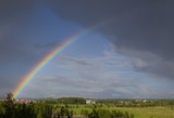 Rainbow after rain over the field