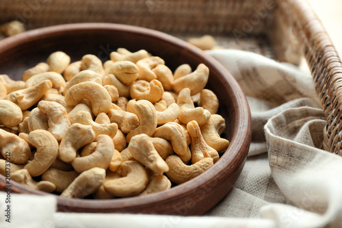 Bowl with tasty cashew nuts, closeup