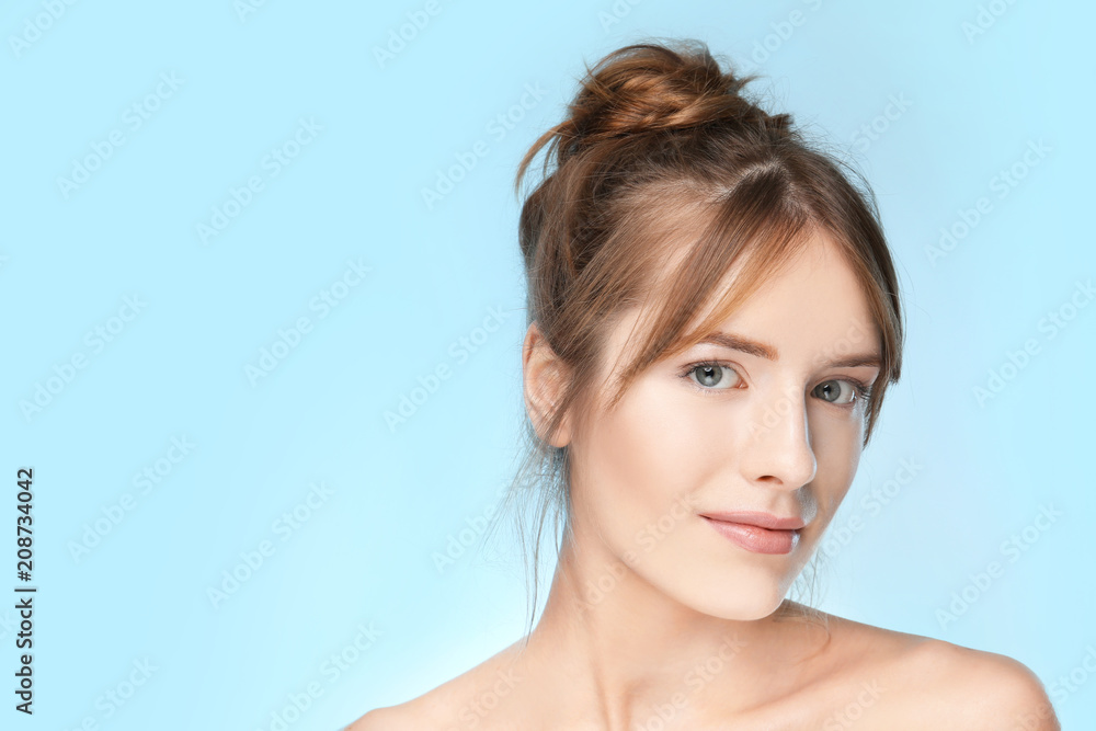 Beautiful young woman with silky skin on color background Beautiful young woman with silky skin on color background