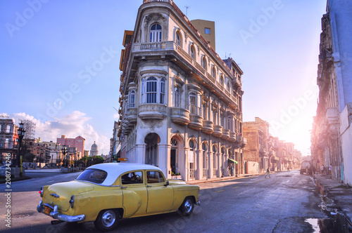 Street with old buildings and a retro car. Havana. Cuba. 