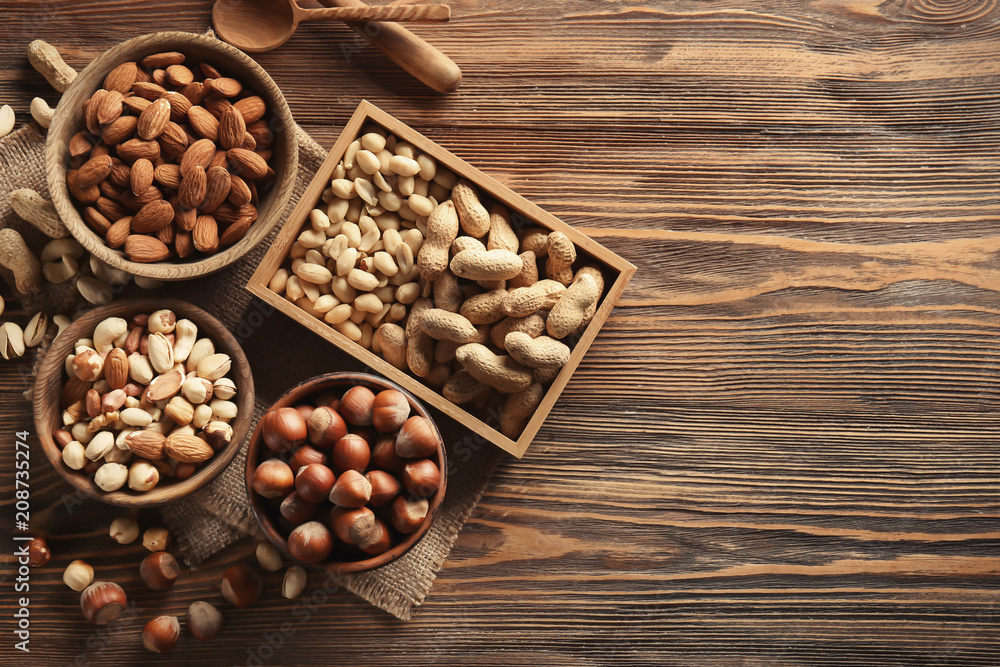 Composition with different nuts on wooden background Composition with different nuts on wooden background