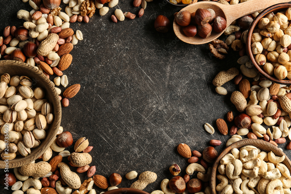 Frame made of different nuts on grey background Frame made of different nuts on grey background