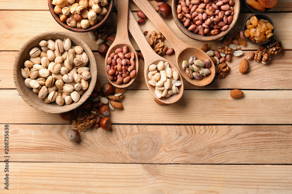 Obraz premium Composition with different nuts on wooden background