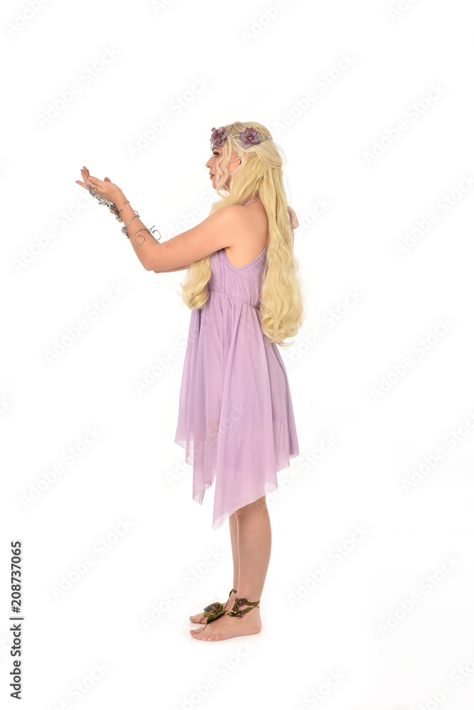 full length portrait of pretty blonde girl wearing purple fairy dress. standing pose, isolated on white studio background. full length portrait of pretty blonde girl wearing purple fairy dress. standing pose, isolated on white studio background.