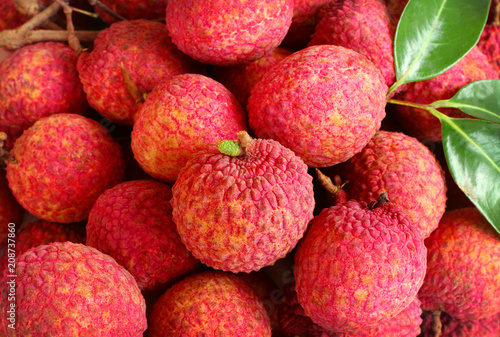background of fresh red skin lychee with leaves.
