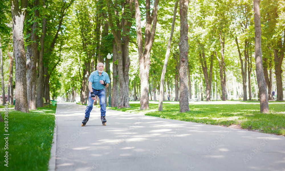 Fototapeta premium Senior man roller skating outdoors