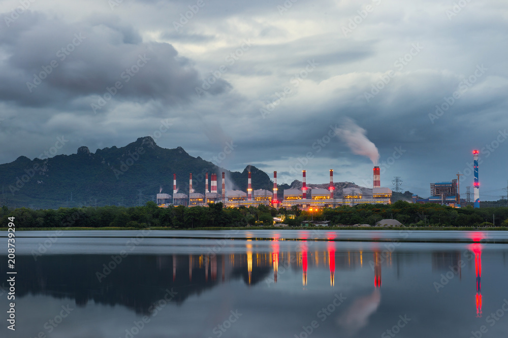 Naklejka premium Industrial power plant with smokestack near the river