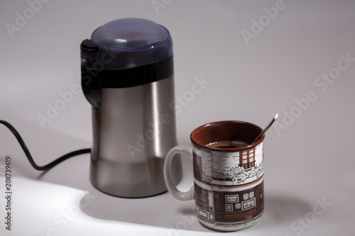 cup of coffee and grinder