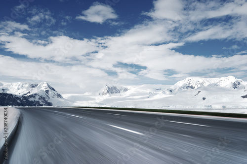 empty asphalt road with snow mountain