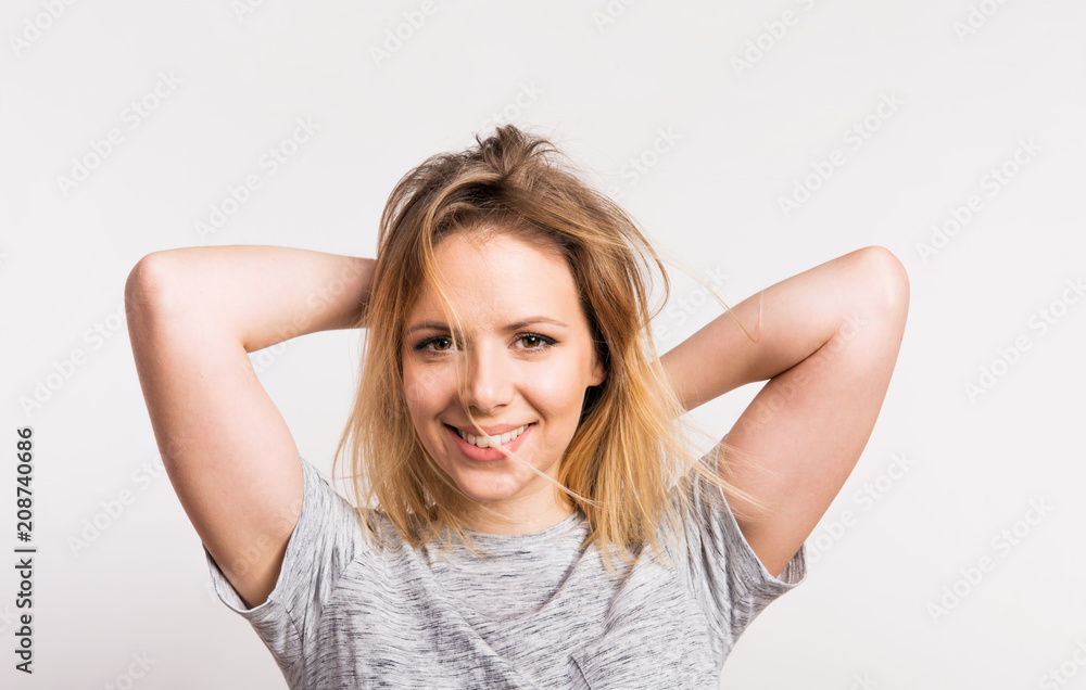 Portrait of a young beautiful woman in studio on a white background. Portrait of a young beautiful woman in studio on a white background.