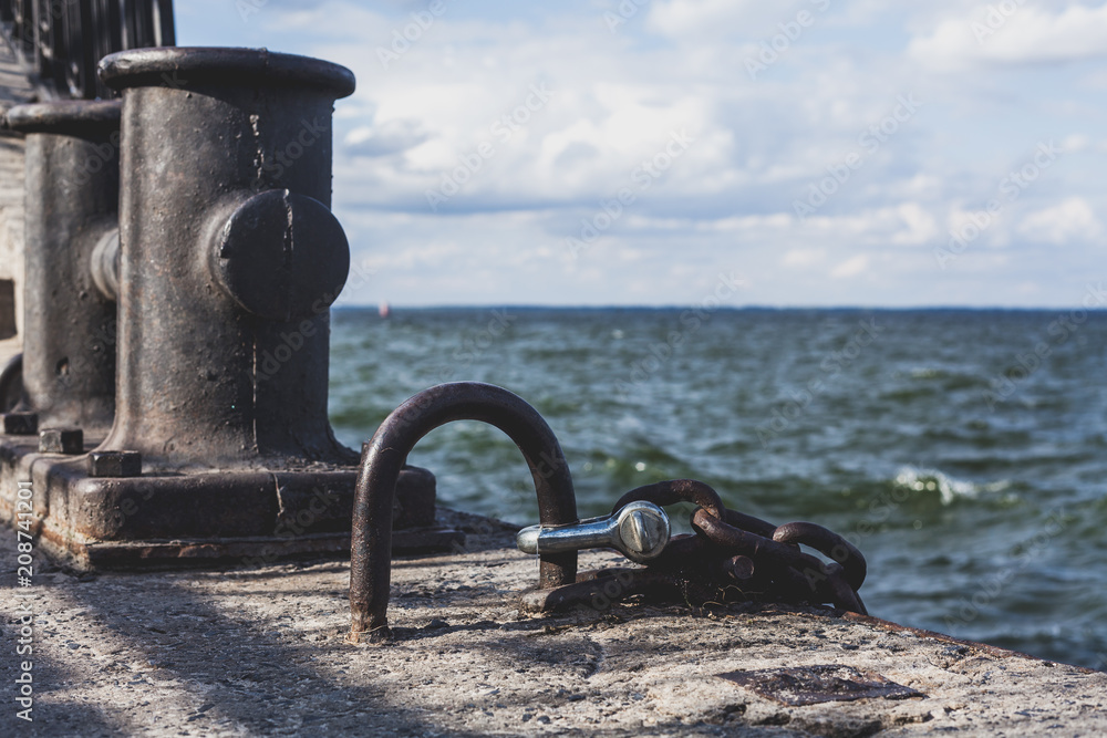 Powerful metal mesh and concrete bollard on dock Powerful metal mesh and concrete bollard on dock