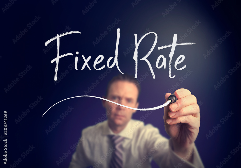 A businessman writing a Fixed Rate concept with a white pen on a clear screen. A businessman writing a Fixed Rate concept with a white pen on a clear screen.
