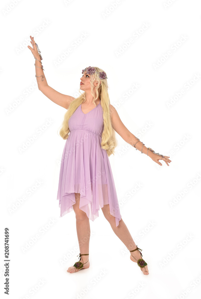full length portrait of pretty blonde girl wearing purple fairy dress. standing pose, isolated on white studio background. full length portrait of pretty blonde girl wearing purple fairy dress. standing pose, isolated on white studio background.