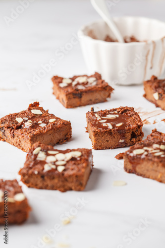 Pieces of vegan sweet potato brownie on white table. Healthy vegan food concept.