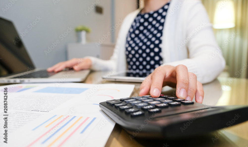 Woman hand using a calculator. Woman hand using a calculator.