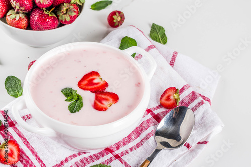 Sweet creamy strawberry soup, vegan summer food, white marble background copy space