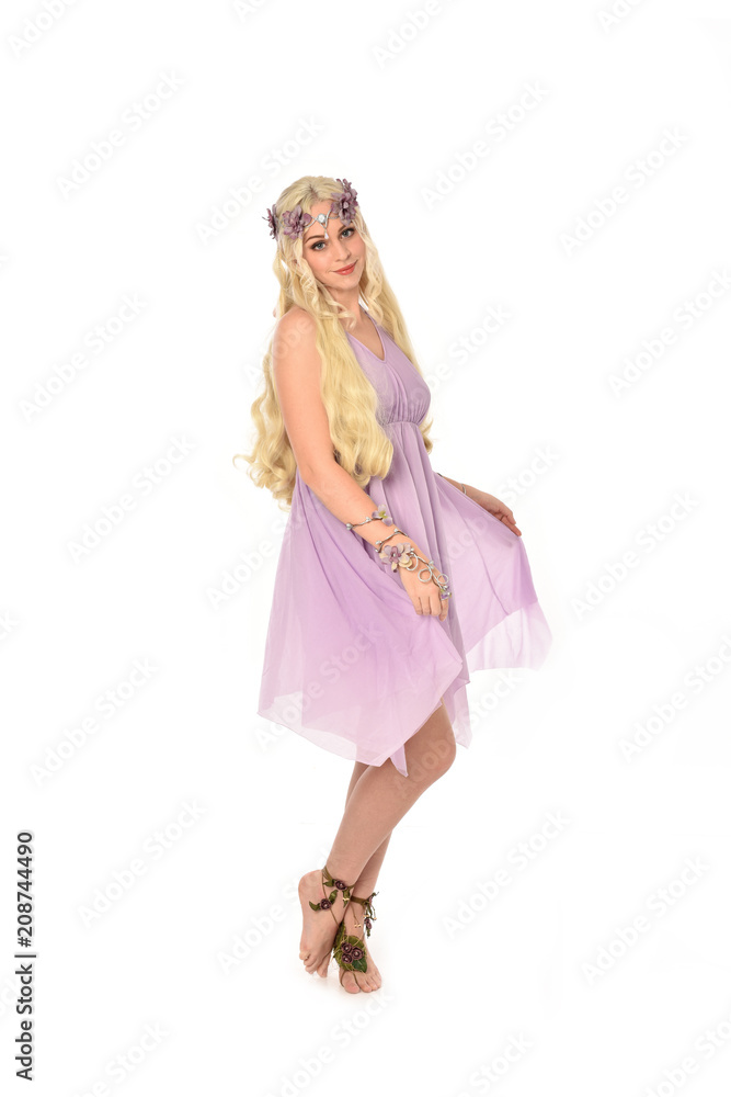 full length portrait of pretty blonde girl wearing purple fairy dress. standing pose, isolated on white studio background. full length portrait of pretty blonde girl wearing purple fairy dress. standing pose, isolated on white studio background.
