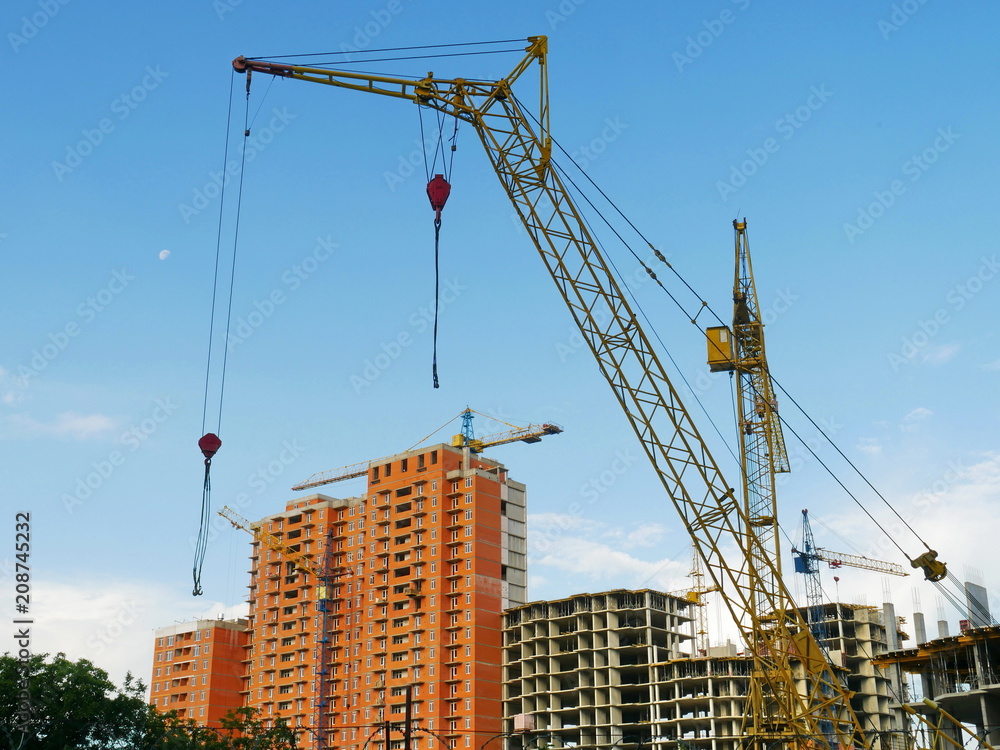 Сrane near building.  Construction site. Buildings under construction.